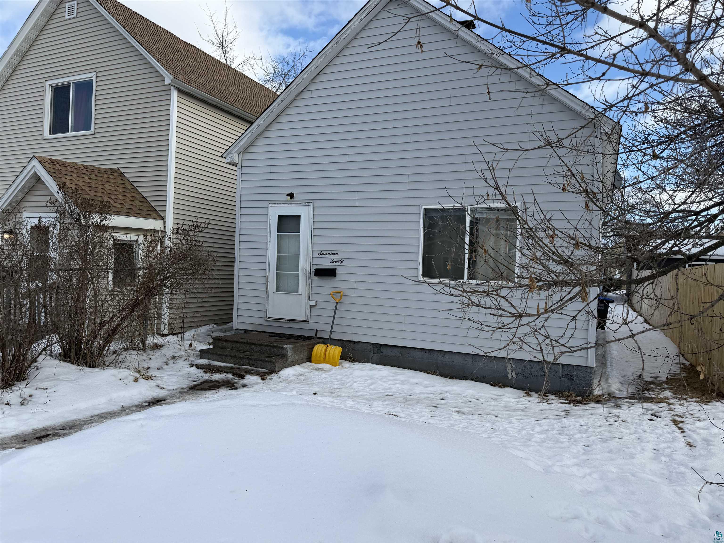1720 Iowa Avenue Superior, WI 54880 - Photo 1 of 11 Snow covered rear of property with a shingled roof
