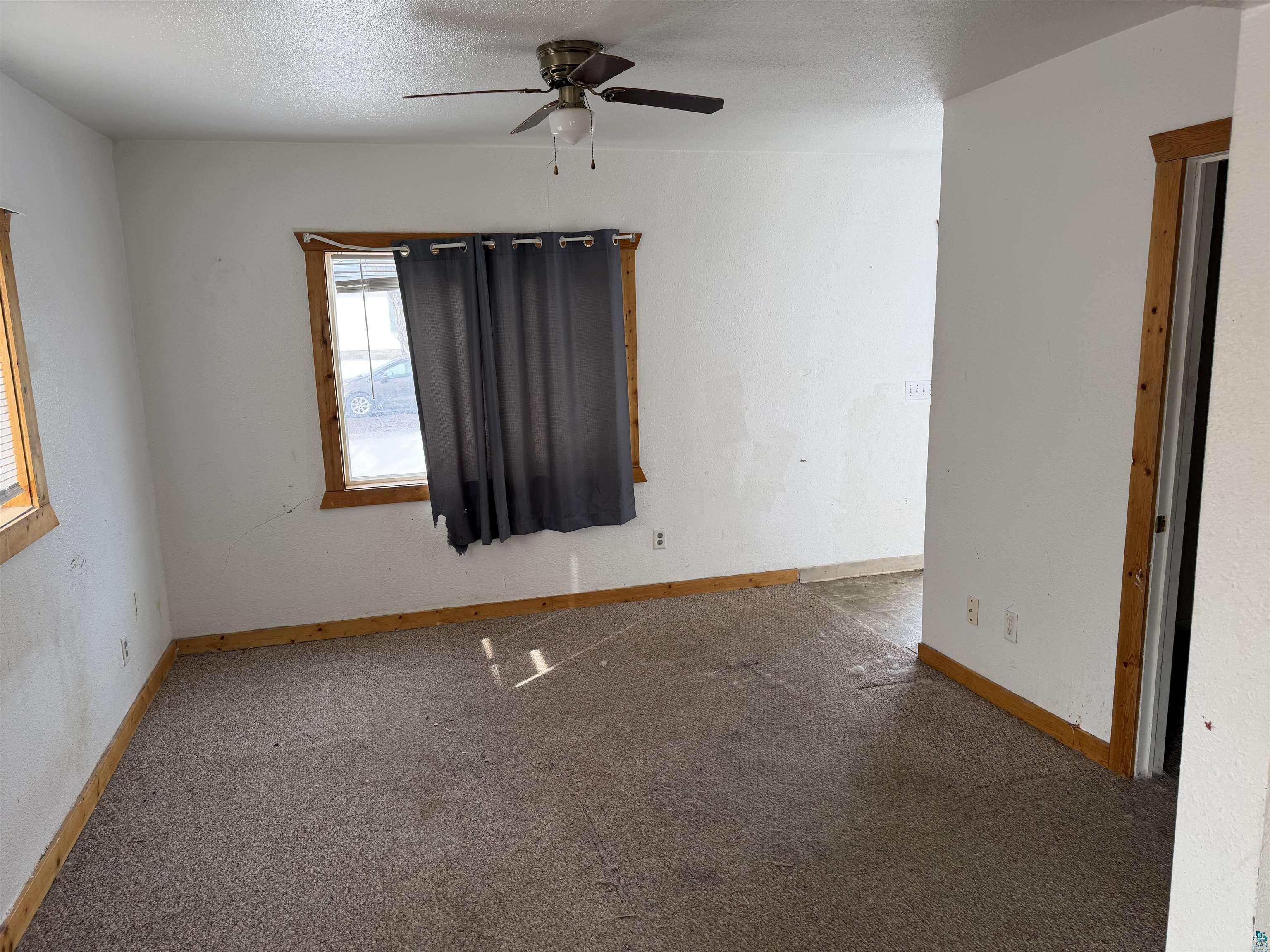 1720 Iowa Avenue Superior, WI 54880 - Photo 4 of 11 Unfurnished room with carpet floors, a ceiling fan, and a textured ceiling