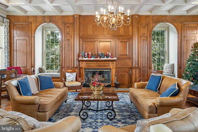 a living room with furniture a chandelier and a large window