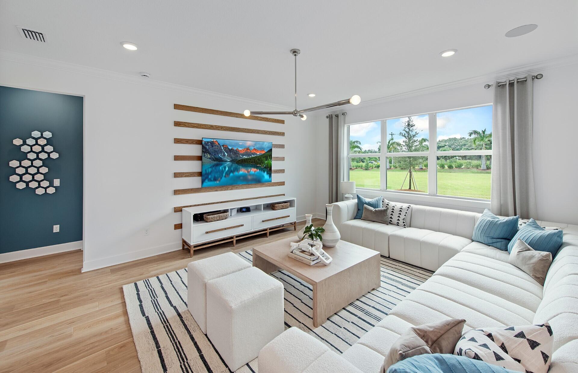 10391 Southwest Highpointe Drive, Unit HIGHGATE 265 Stuart, FL 34997 - Photo 6 of 31 a living room with furniture and a flat screen tv