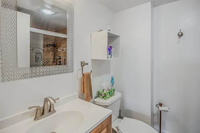 a bathroom with a sink toilet and shower