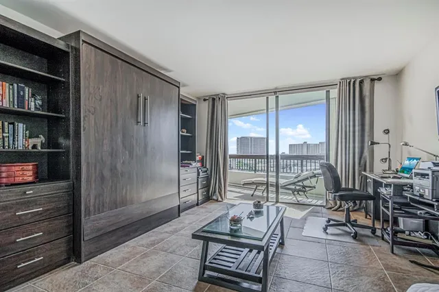 a living room with furniture and a floor to ceiling window