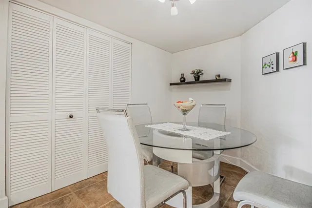a dining room with table and chairs