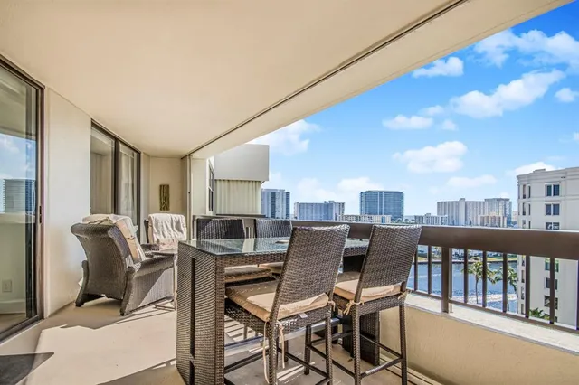 a view of a dining room with furniture and a floor to ceiling window