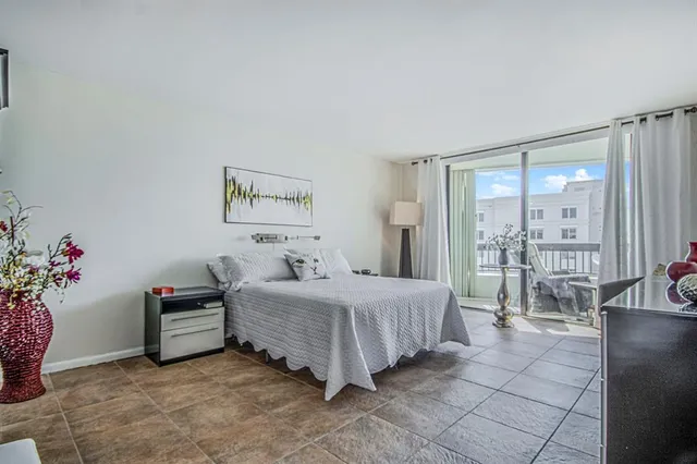 a bedroom with a bed and a potted plant