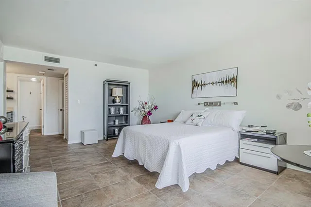 a bedroom with a bed and a table