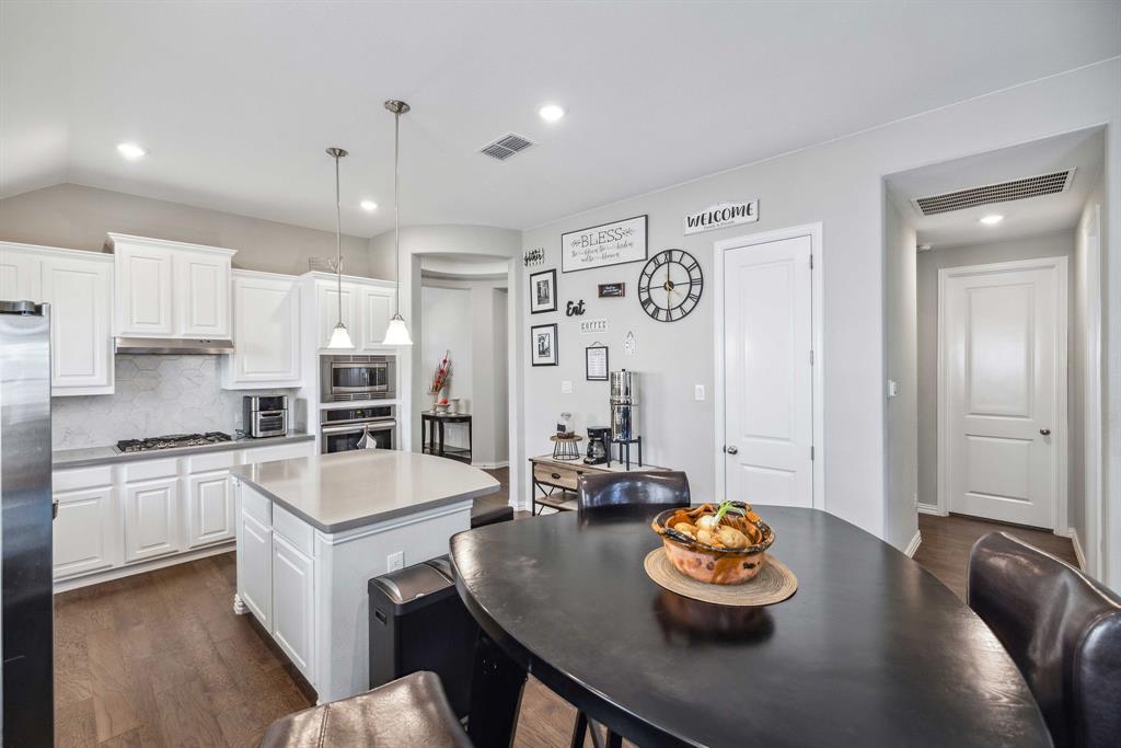 1732 Wassel Road Fort Worth, TX 76052 - Photo 13 of 39 a kitchen with stainless steel appliances granite countertop a sink a stove and a refrigerator