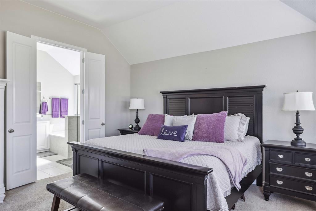 1732 Wassel Road Fort Worth, TX 76052 - Photo 23 of 39 a bedroom with a bed and a lamp on table
