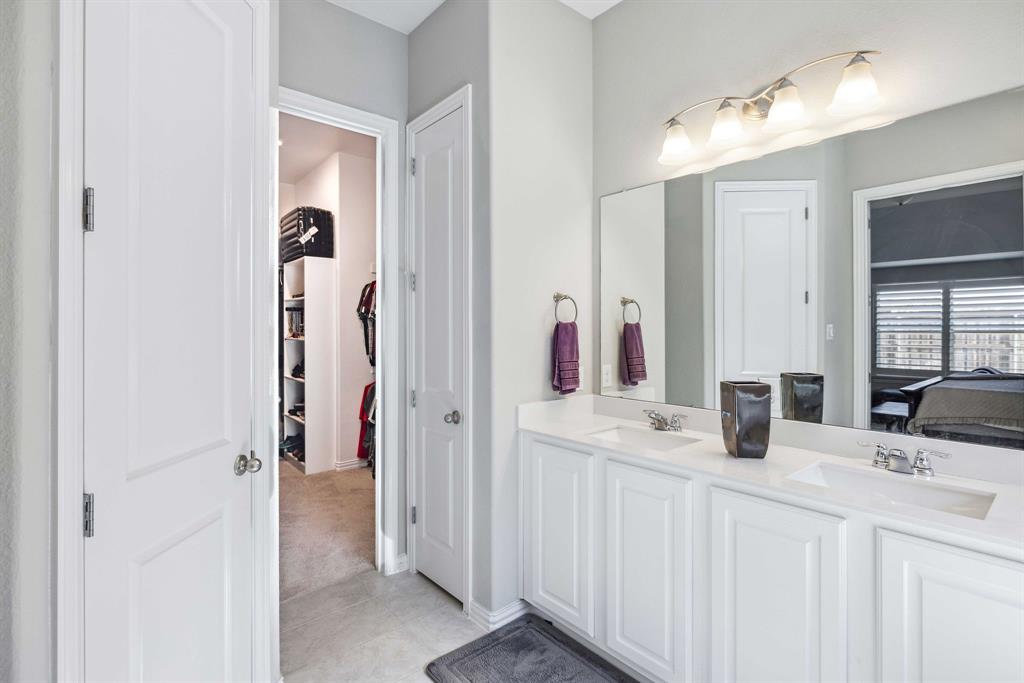 1732 Wassel Road Fort Worth, TX 76052 - Photo 27 of 39 a bathroom with a double vanity sink and a mirror