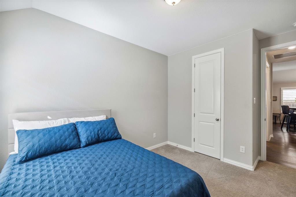 1732 Wassel Road Fort Worth, TX 76052 - Photo 33 of 39 a bedroom with a bed and a cabinets