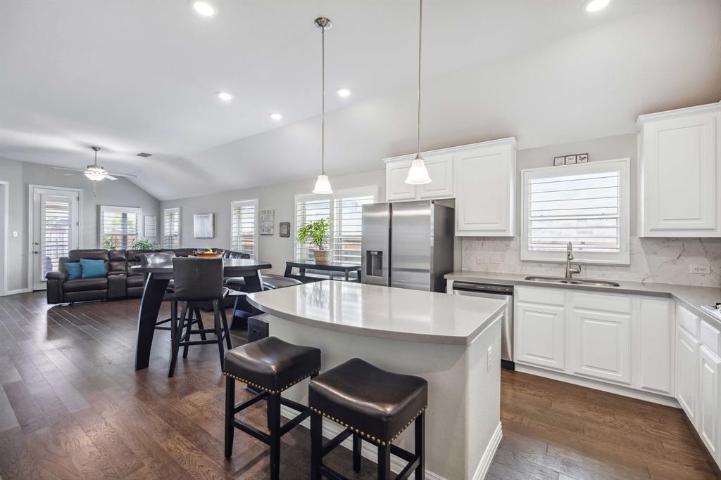 1732 Wassel Road Fort Worth, TX 76052 - Photo 9 of 39 a large kitchen with kitchen island a dining table and chairs