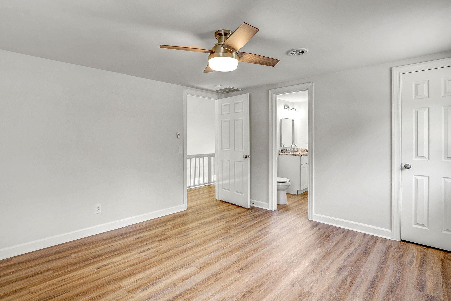 170 Temple Road Bunnlevel, NC 28323 - Photo 24 of 34 an empty room with wooden floor and a ceiling fan