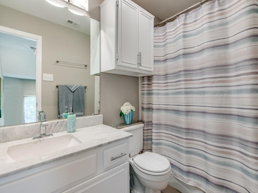 10805 Stone Canyon Road Dallas, TX 75230 - Photo 16 of 19 a bathroom with a granite countertop toilet sink and mirror