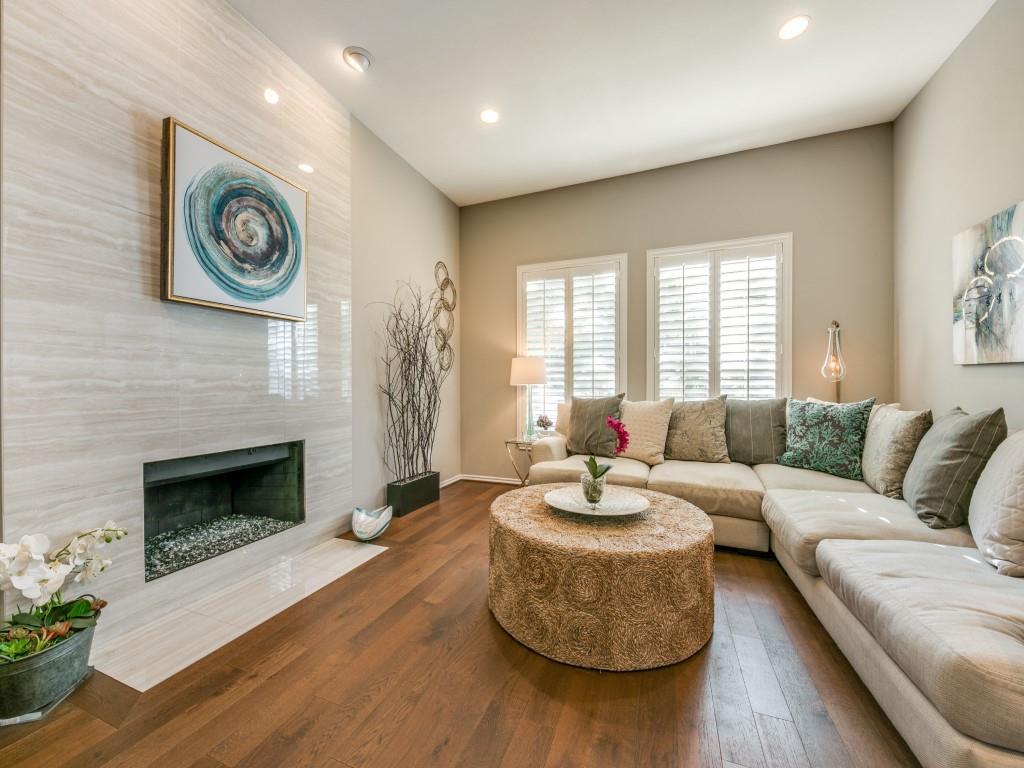 10805 Stone Canyon Road Dallas, TX 75230 - Photo 2 of 19 a living room with furniture a fireplace and a large window