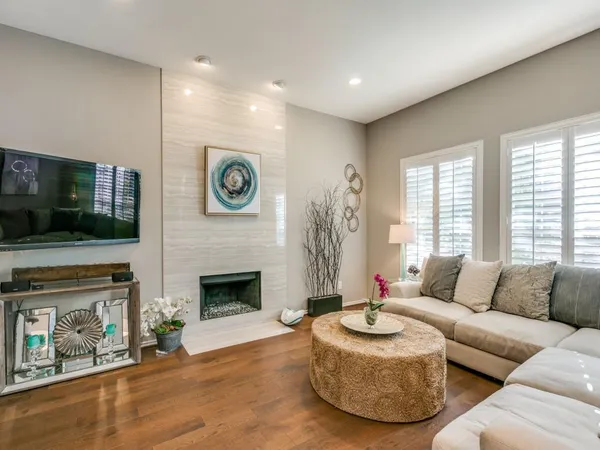 a living room with furniture a flat screen tv and a fireplace