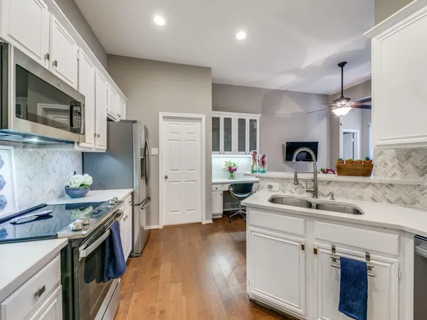 a kitchen with a sink stove and refrigerator