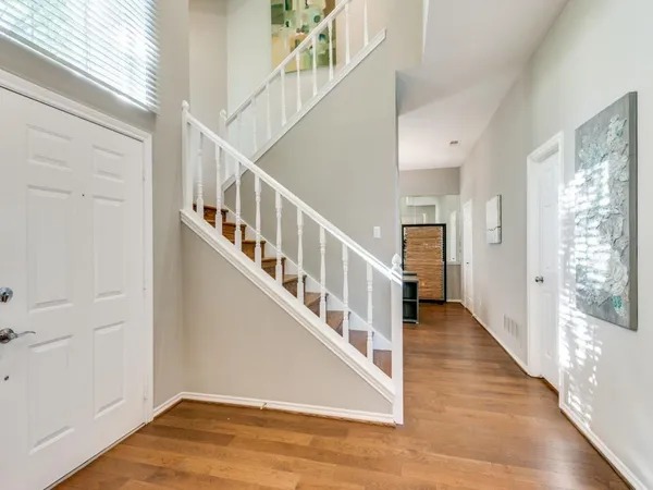 a view of an entryway with wooden floor