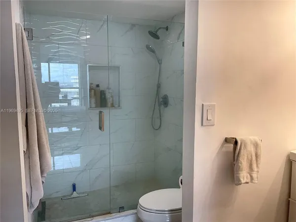 a living room with furniture a rug and a book shelf