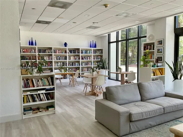 a view of a dining room with furniture large windows and wooden floor
