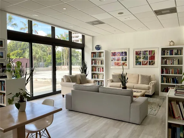 a living room with furniture and large windows