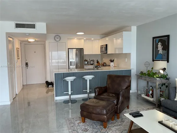 a kitchen with stainless steel appliances granite countertop a refrigerator stove a sink and a microwave