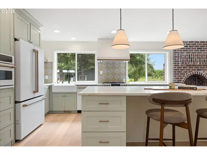 a kitchen with a sink a window and stainless steel appliances