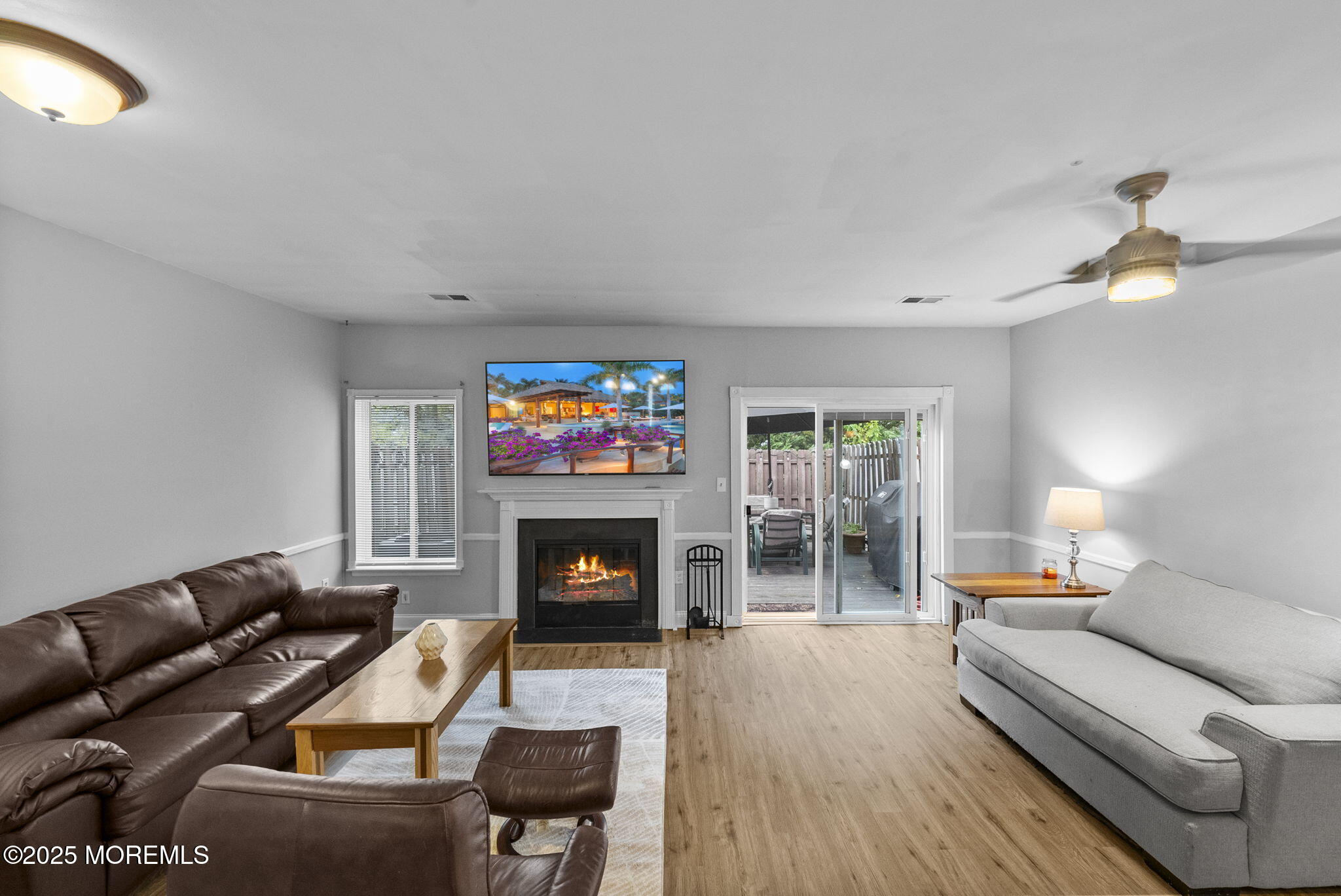 74 Lexington Circle Matawan, NJ 07747 - Photo 17 of 48 a living room with furniture a flat screen tv and a fireplace