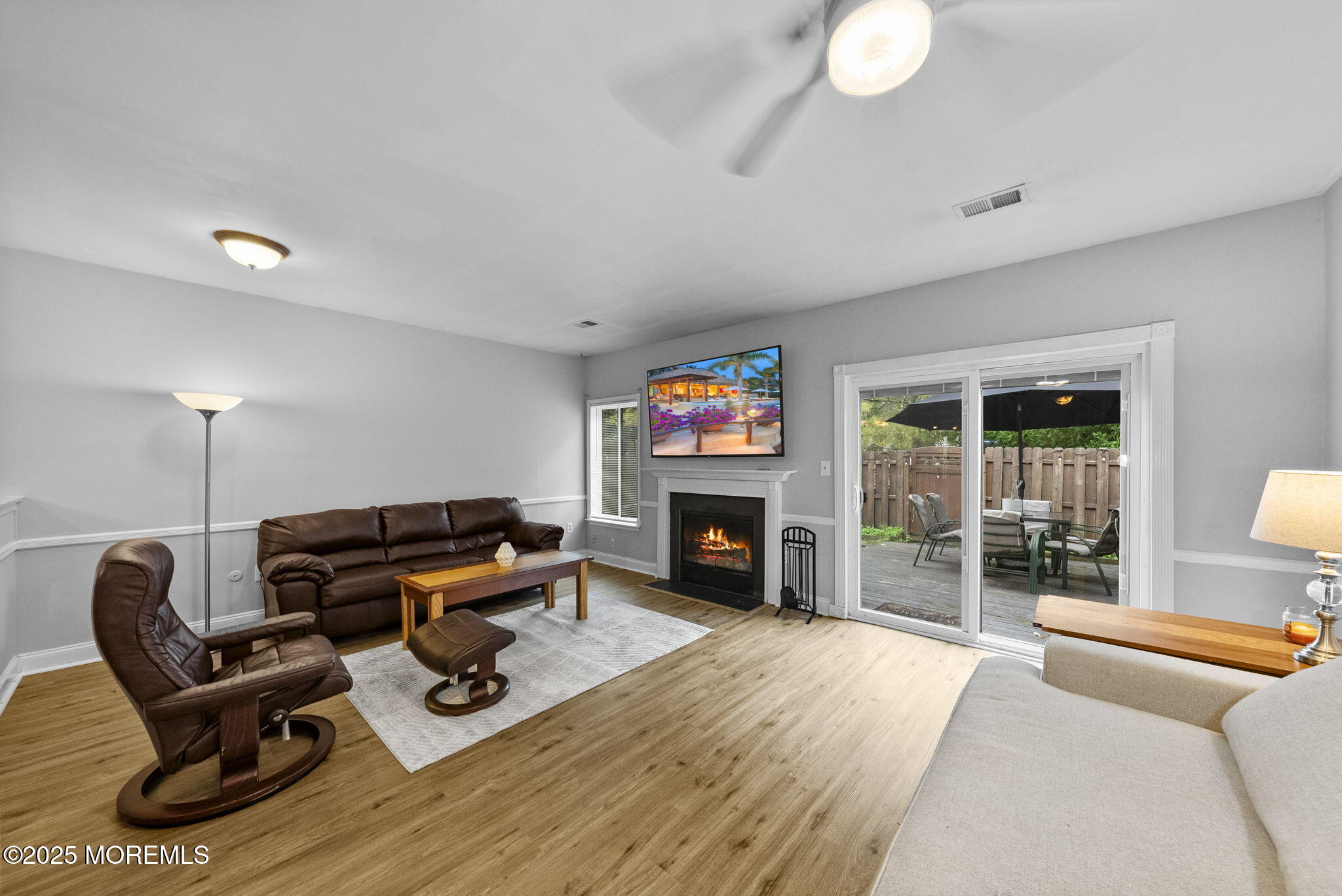 74 Lexington Circle Matawan, NJ 07747 - Photo 18 of 48 a living room with furniture a fireplace and a floor to ceiling window