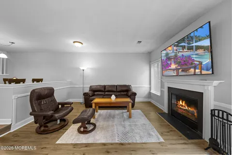 a living room with furniture a fireplace and rug