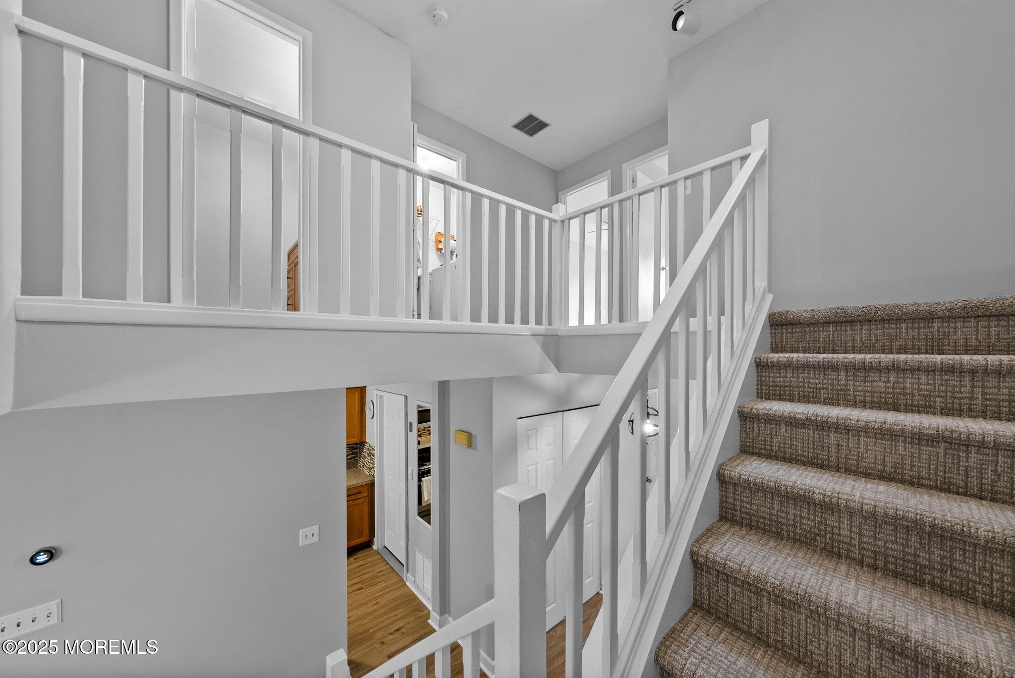 74 Lexington Circle Matawan, NJ 07747 - Photo 22 of 48 a view of staircase with lots of frames on wall and a window