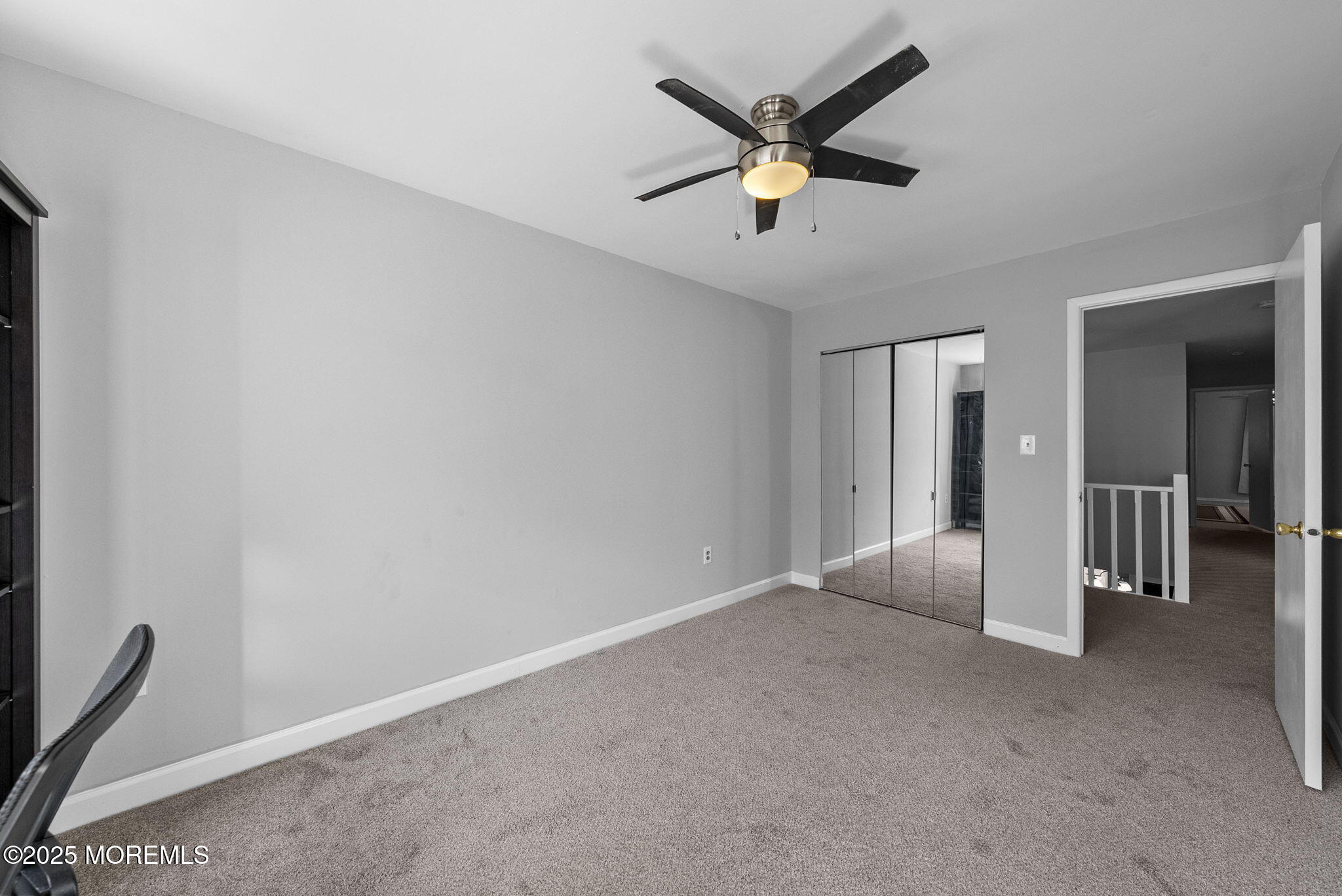 74 Lexington Circle Matawan, NJ 07747 - Photo 27 of 48 an empty room with chandelier fan and windows