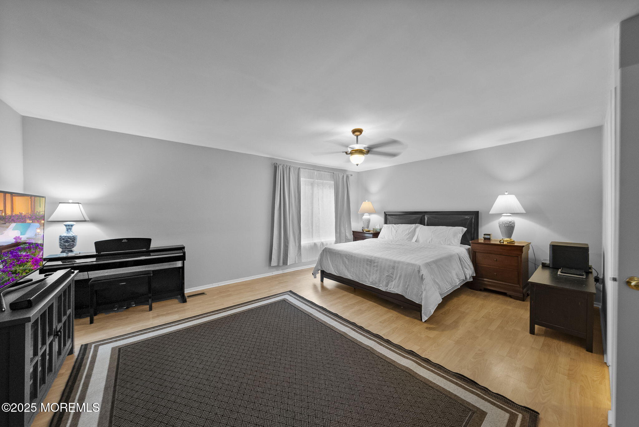 74 Lexington Circle Matawan, NJ 07747 - Photo 32 of 48 a bedroom with a bed and a chandelier