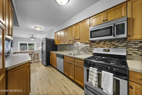 a kitchen with stainless steel appliances granite countertop a stove and a sink