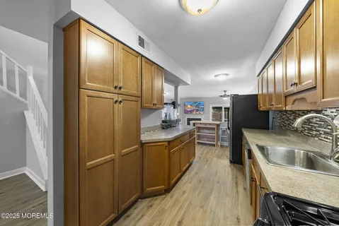 a kitchen with refrigerator cabinets and wooden floor