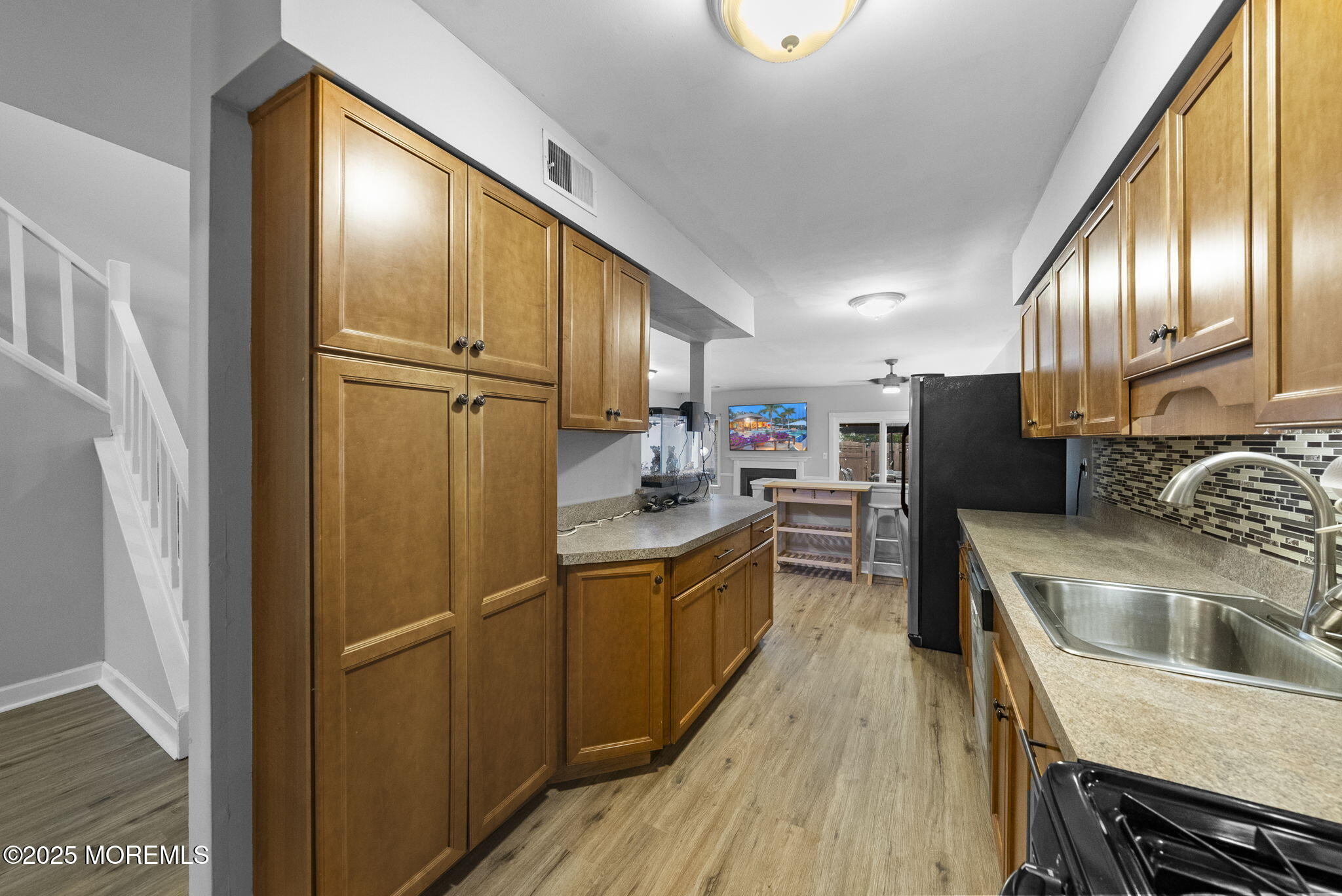 74 Lexington Circle Matawan, NJ 07747 - Photo 10 of 48 a kitchen with refrigerator cabinets and wooden floor