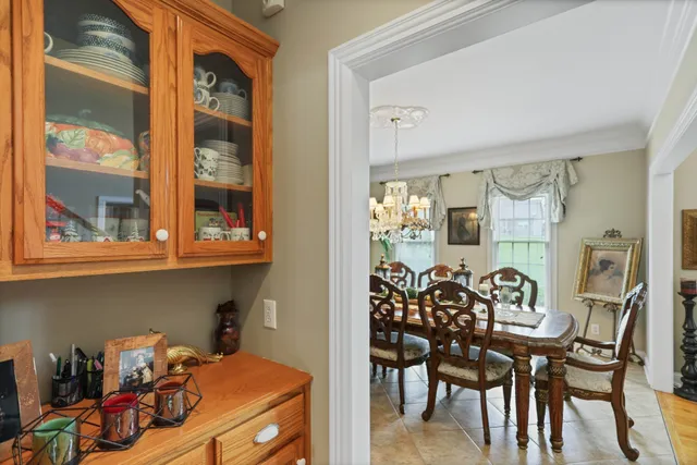 a living room with furniture a bookshelf and a window