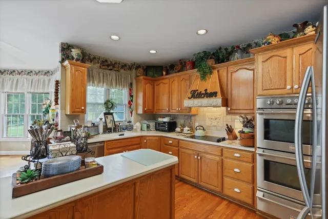 a en suite bathroom with a double vanity sink a mirror and a bathtub