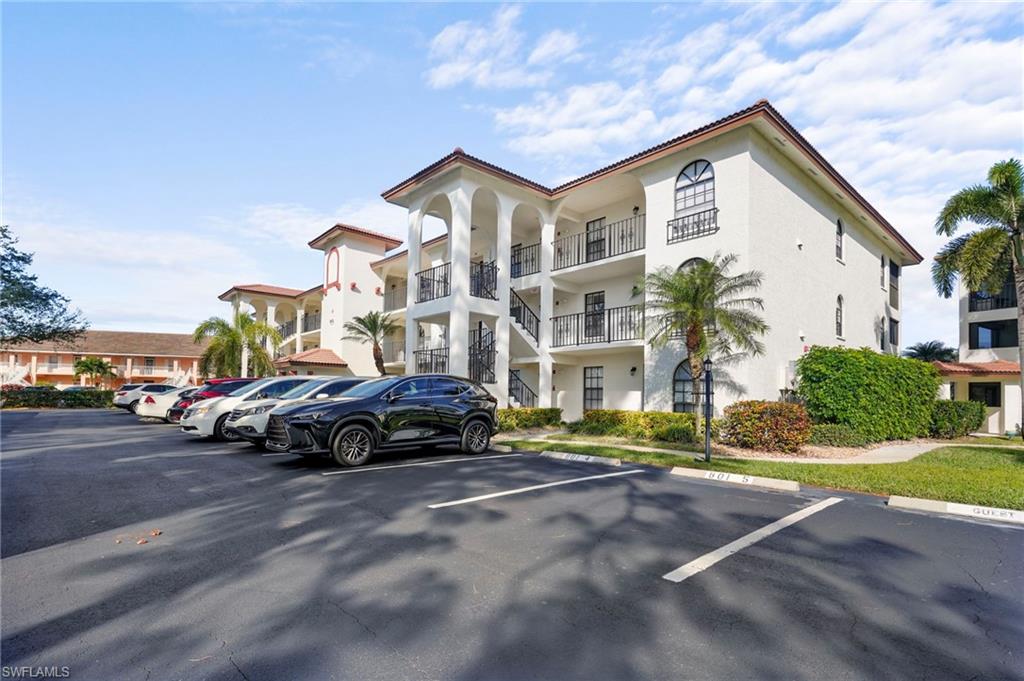 601 Augusta Boulevard, Unit 10 Naples, FL 34113 - Photo 25 of 27 View of apartmenbuilding / complex featuring uncovered parking