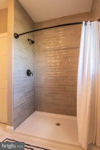 a bathroom with a shower and a tub