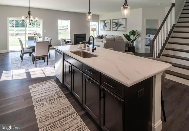 a kitchen with stainless steel appliances a microwave a sink a stove and cabinets