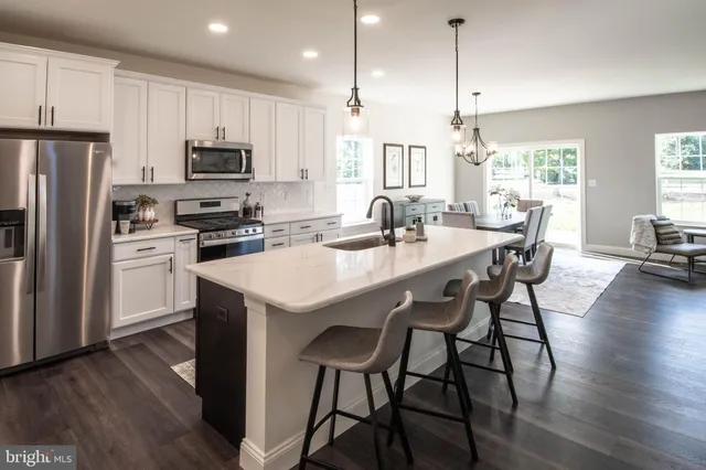a kitchen with sink cabinets and stove top oven