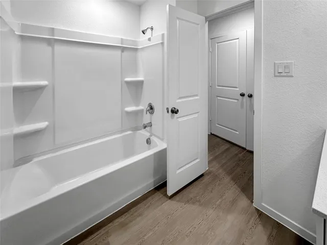 a bathroom with a bathtub and a shower