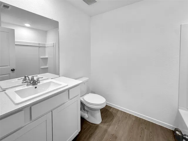 a bathroom with a sink a toilet and mirror