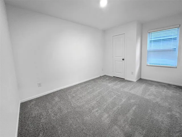 a view of an empty room and a window