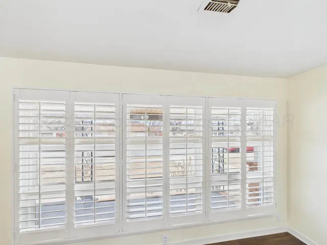a view of wooden floor and windows in a room