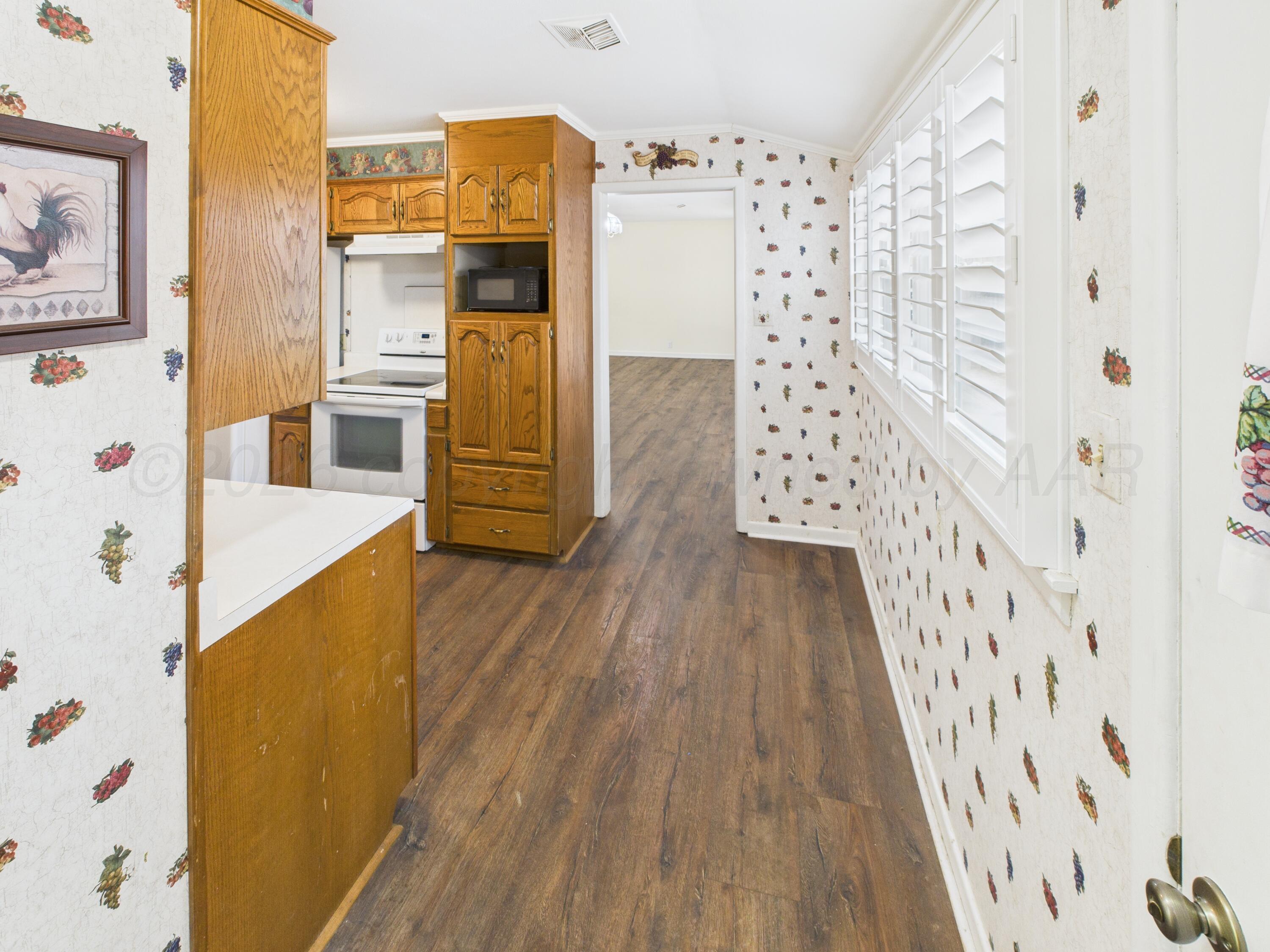 528 North Red Deer Street Pampa, TX 79065 - Photo 17 of 41 a view of walk in closet with wooden floor