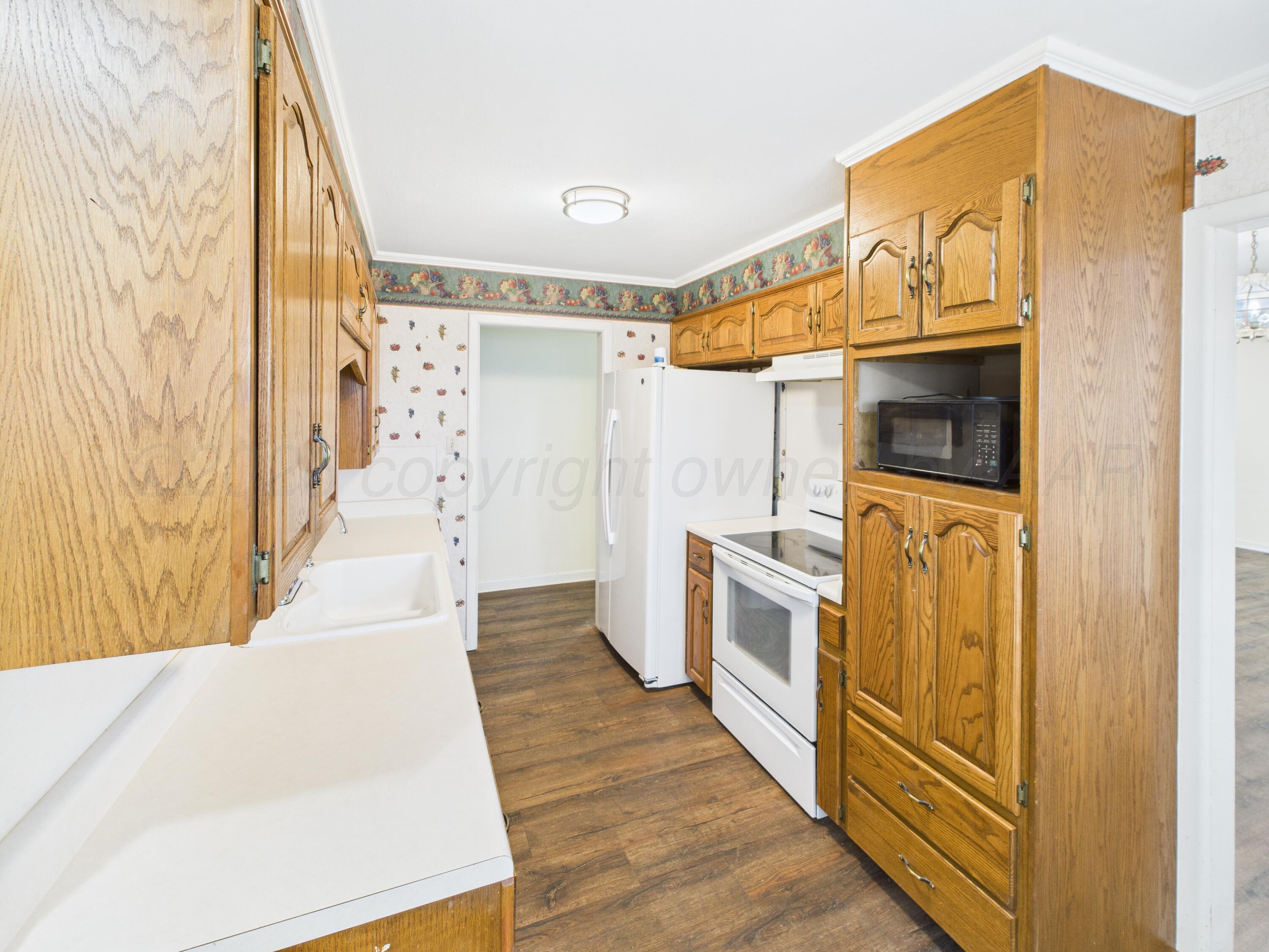 528 North Red Deer Street Pampa, TX 79065 - Photo 18 of 41 a kitchen with stainless steel appliances a refrigerator and a stove