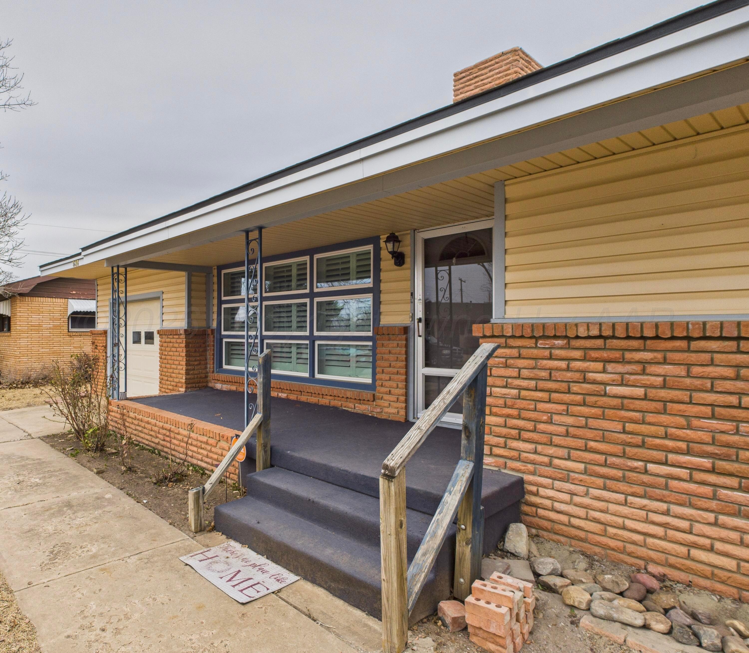 528 North Red Deer Street Pampa, TX 79065 - Photo 2 of 41 a balcony with wooden bench and a potted plant