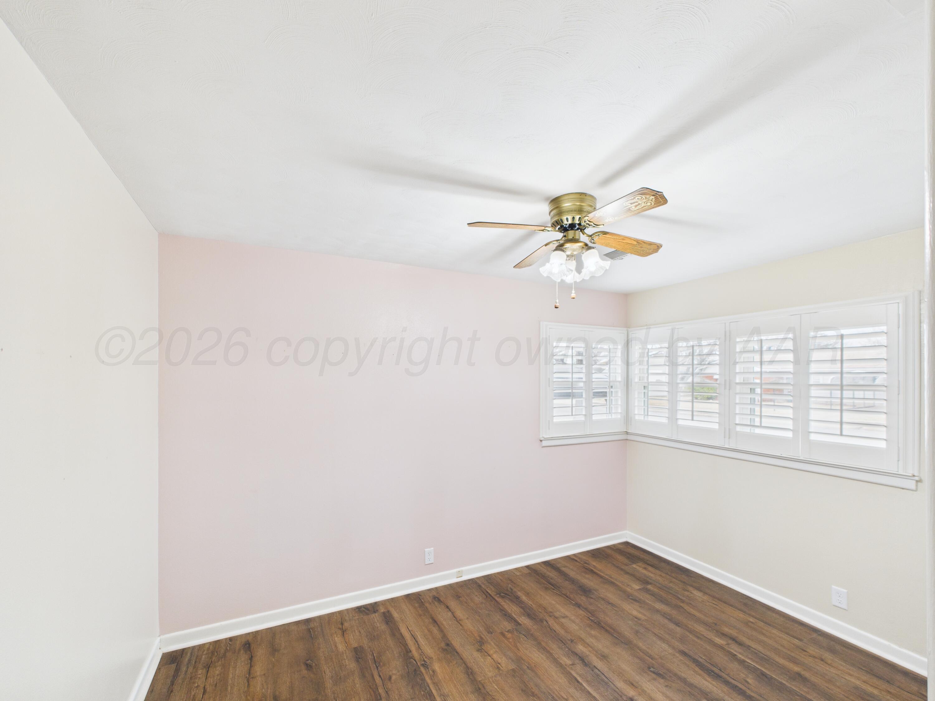 528 North Red Deer Street Pampa, TX 79065 - Photo 30 of 41 an empty room with a window and wooden floor