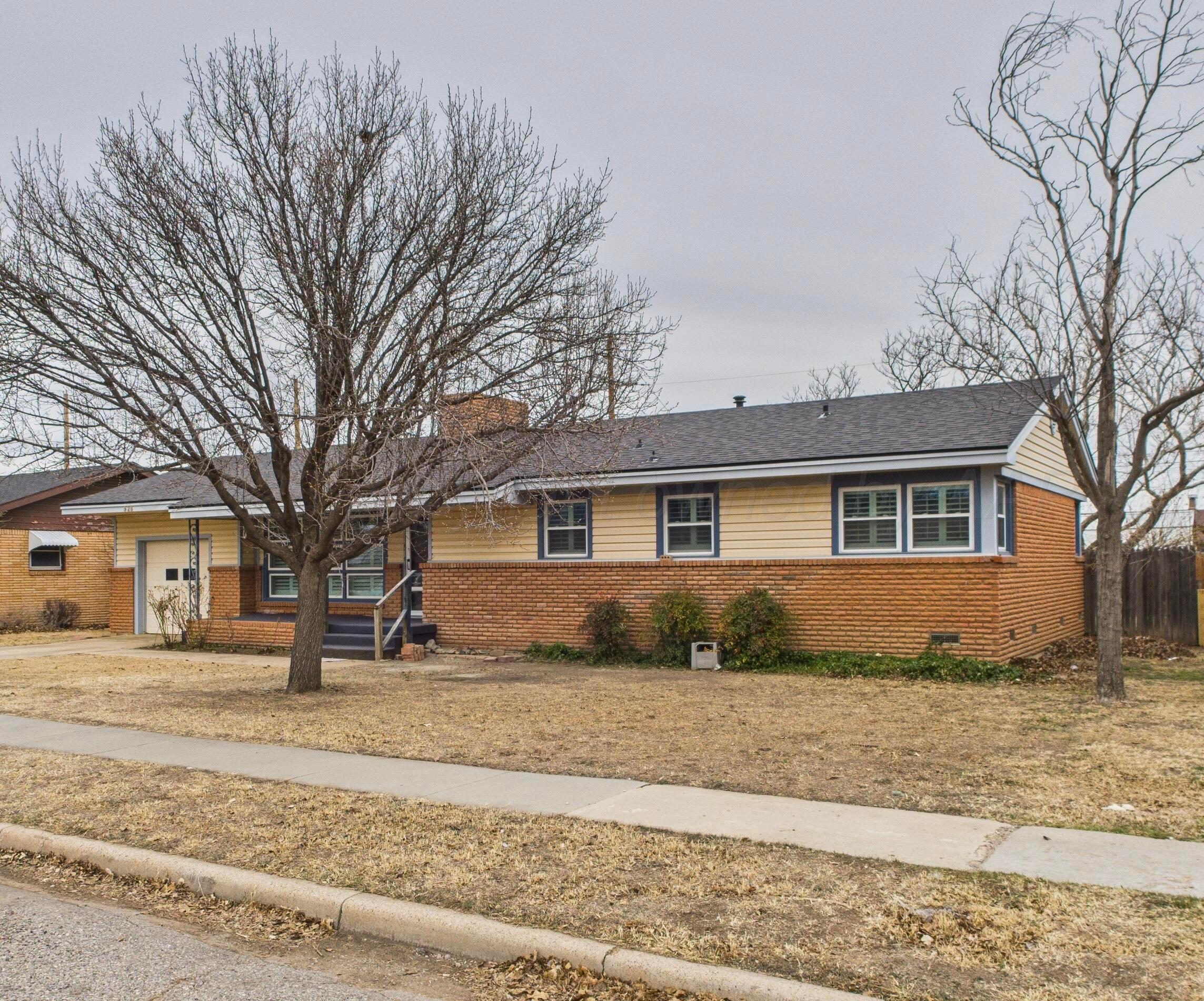 528 North Red Deer Street Pampa, TX 79065 - Photo 3 of 41 a front view of a house with a yard covered in snow